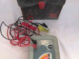 a box with wires and a meter on a table