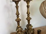 three candles that are sitting on a table next to a mirror