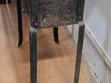 a small table with a potted plant on top of it
