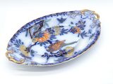 a blue and white plate with flowers and birds on it