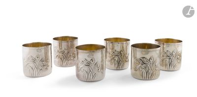 six coupes en argent ornées de motifs, posées sur une surface blanche