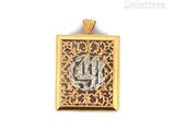 an image of a gold and silver pendant with a monogram on it