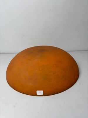 a large orange object sitting on a white surface