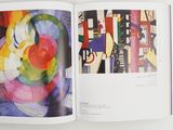an open book with a picture of a painting on it