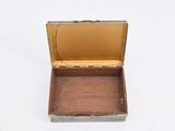 a small metal box that is open on a white surface