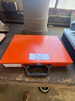 an orange box sitting on top of a table next to a pile of other items
