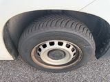 a white car with a flat tire on the side of the road