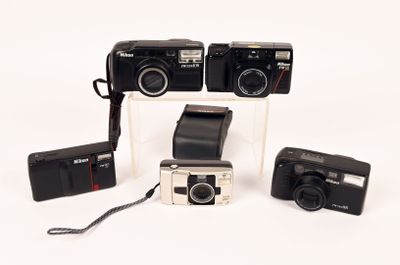 three cameras that are sitting next to each other on a table