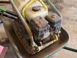 a wheelbarrow with a mower on it in a garage