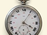 une montre de poche en argent avec des chiffres romains sur le cadran