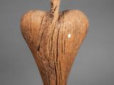an image of a wooden sculpture of a heart on a stand