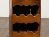 an old wooden wine rack with a wine bottle holder on top of it