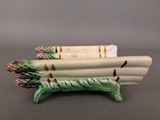 green and white ceramic asparagus planter sitting on top of a table