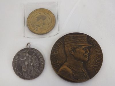 two coins and a coin with a picture of a man in a military uniform