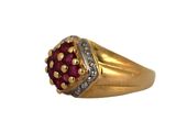 an image of a close up of a ring with a red stone