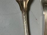 two forks sitting next to each other on a table
