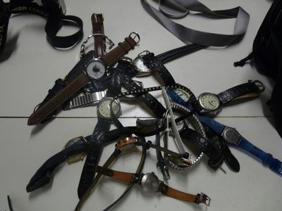 a lot of different types of watches on the table