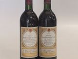 two bottles of wine sitting next to each other on a table
