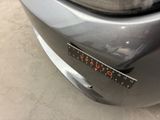 a close up of a car ' s front bumper with a sticker on it