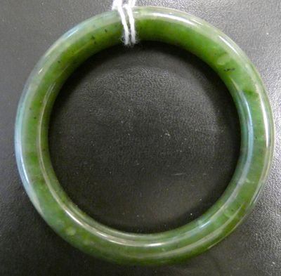an image of a green jade bangle with a string around it