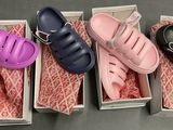 three pairs of shoes are in a box on a table