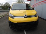 a yellow van parked in a parking lot next to a building