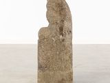 an old stone sculpture of a man ' s head on a pedestal