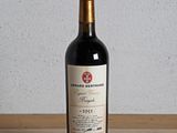 une bouteille de vin rouge posée sur une table en bois