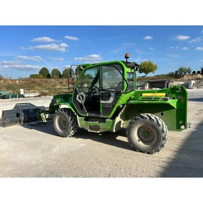 a picture of a green tractor parked in a parking lot