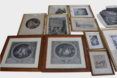 a lot of framed pictures on the wall of this room