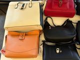 a lot of purses that are on a table