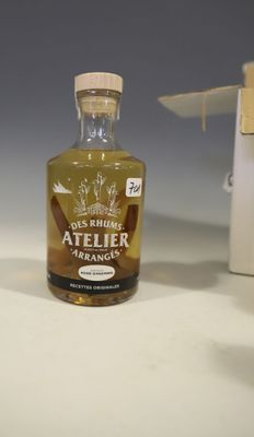 a bottle of alcohol sitting on a table next to a knife