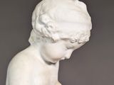 marble statue of a child reading a book