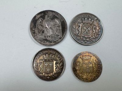 four different types of coins sitting on top of a white surface
