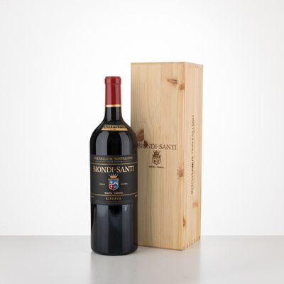 the bottle of wine is next to a wooden box