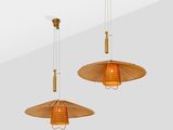 two hanging lamps made of rattan wood and glass on a white wall