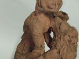 statue of a man and a woman hugging on a rock