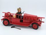 a red toy fire truck with a man in it