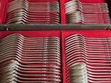 many spoons in a red case on a table