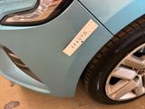 a close up of a blue car with a sticker on it