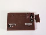 a small brown electronic device on a white surface