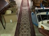 un long tapis au milieu d'une pièce remplie de meubles