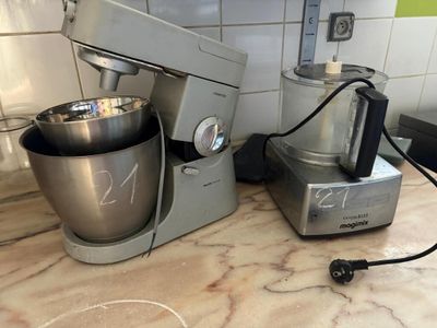 a mixer and a blender sitting on a kitchen counter