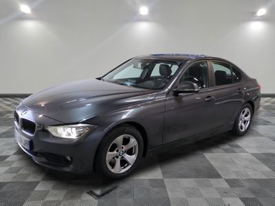 a picture of a gray bmw car in a garage