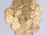 a pile of gold coins sitting on a white surface