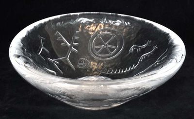 a glass bowl with a design on it on a black background