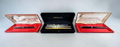 three pens in a case sitting on a table next to each other