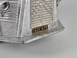 an old fashioned silver toaster on a white table
