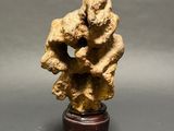 an image of a statue of a man holding a dog on top of a wooden base