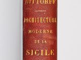 un vieux livre rouge orné de lettres dorées, posé sur une surface blanche